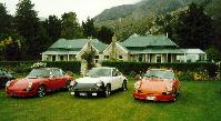 [Porsches outside homestead]